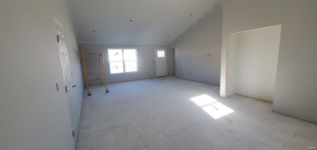 unfurnished room with high vaulted ceiling