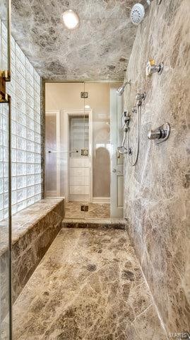 bathroom with tiled shower