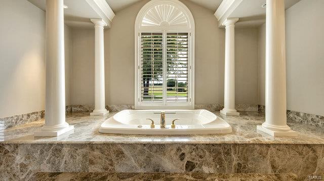 bathroom featuring a relaxing tiled tub