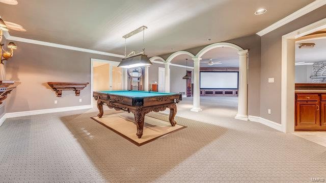 game room featuring decorative columns, pool table, crown molding, and light colored carpet