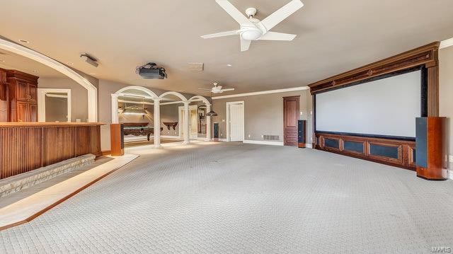 cinema featuring ornamental molding, carpet, and ceiling fan