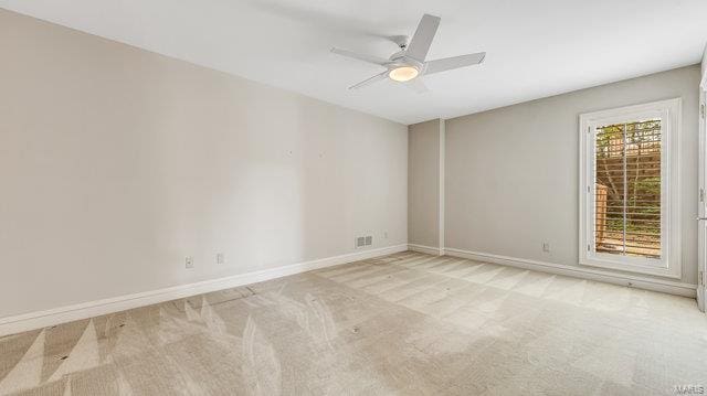 empty room with light colored carpet and ceiling fan