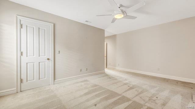 empty room featuring light carpet and ceiling fan