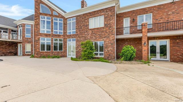 view of front of home with french doors and a balcony