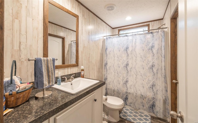 bathroom with vanity, ornamental molding, a textured ceiling, a shower with curtain, and toilet