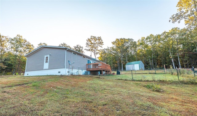 exterior space featuring cooling unit, a deck, and a shed