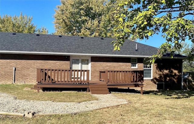 back of property with a lawn and a wooden deck