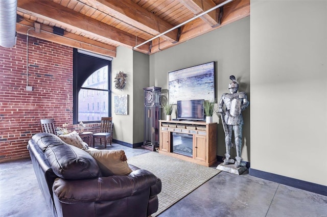 living room featuring wood ceiling, beamed ceiling, a fireplace, concrete flooring, and brick wall