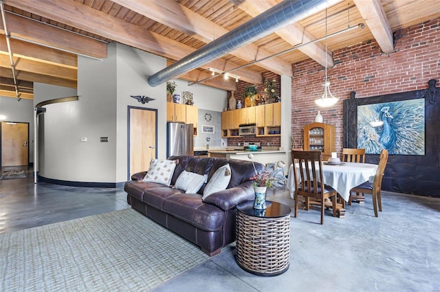 living room with beamed ceiling, a towering ceiling, and wooden ceiling