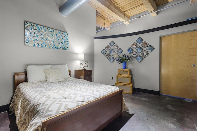 bedroom with a closet, beam ceiling, and wood ceiling