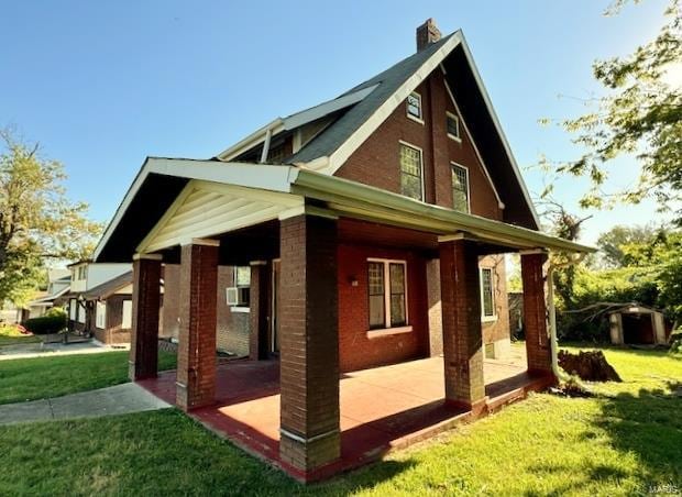 view of side of property with a yard, cooling unit, and a patio area