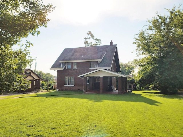 rear view of house featuring a porch and a yard