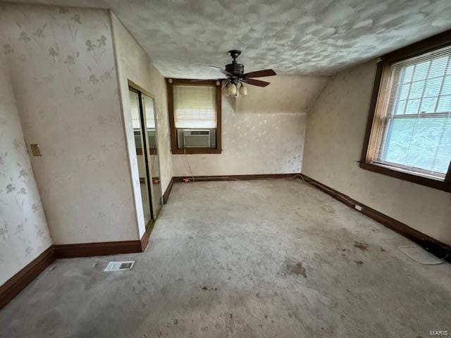 additional living space featuring lofted ceiling, cooling unit, and ceiling fan