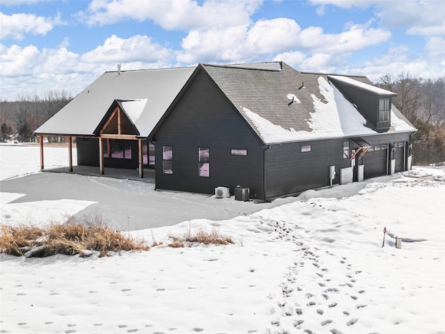 snow covered house with a garage