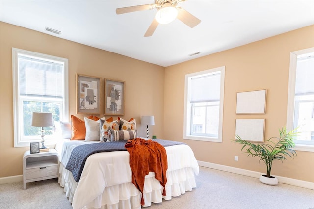 bedroom featuring ceiling fan and light carpet