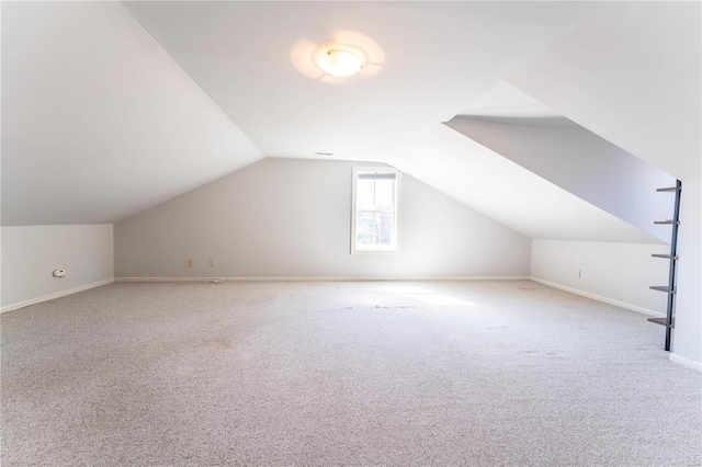 bonus room featuring vaulted ceiling and carpet flooring