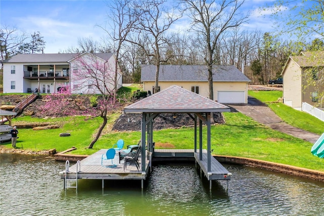 view of dock with a gazebo, a yard, and a water view