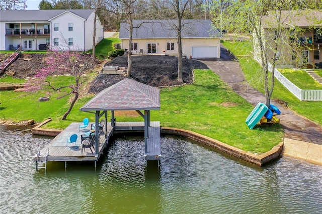 dock area featuring a water view and a lawn