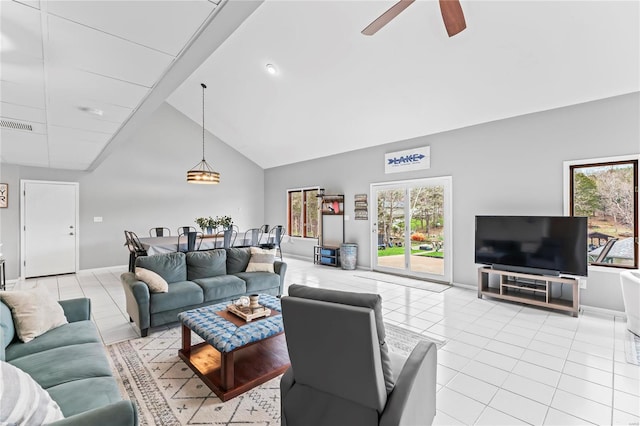 living room featuring high vaulted ceiling, ceiling fan, and light tile patterned flooring