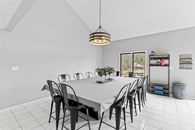 dining space featuring light tile patterned floors, high vaulted ceiling, and a notable chandelier