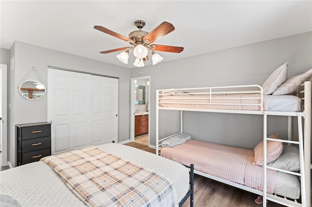 bedroom featuring a closet, connected bathroom, ceiling fan, and dark hardwood / wood-style floors