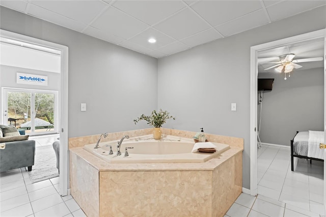 bathroom featuring a bath, a paneled ceiling, tile patterned floors, and ceiling fan