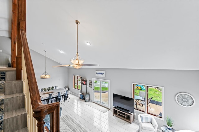 tiled living room with high vaulted ceiling and ceiling fan