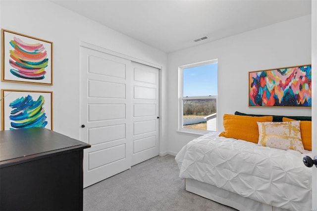 carpeted bedroom with a closet