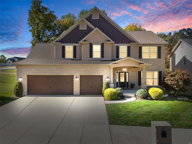 view of front of home featuring a yard, stone siding, board and batten siding, and driveway