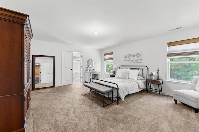 carpeted bedroom with multiple windows, baseboards, and visible vents