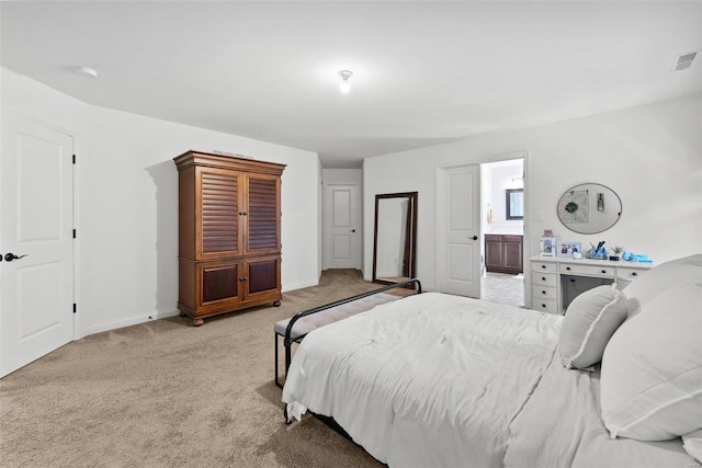 bedroom with carpet flooring, connected bathroom, visible vents, and baseboards