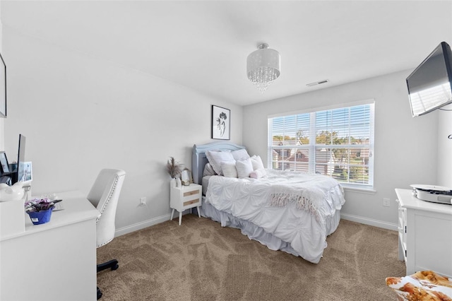 bedroom with light colored carpet, visible vents, and baseboards