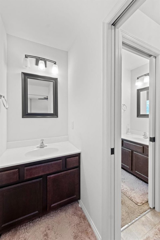 bathroom with vanity and baseboards