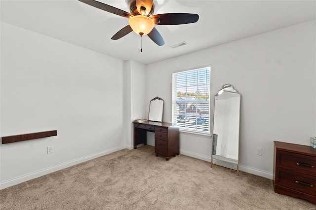 interior space with visible vents, light carpet, baseboards, and a ceiling fan