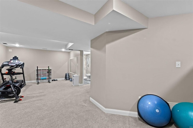 exercise room featuring carpet and baseboards