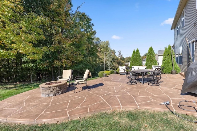 view of patio with outdoor dining space and an outdoor fire pit