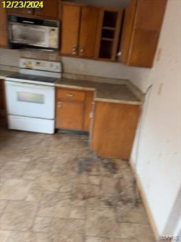 kitchen with white electric range, open shelves, and brown cabinets