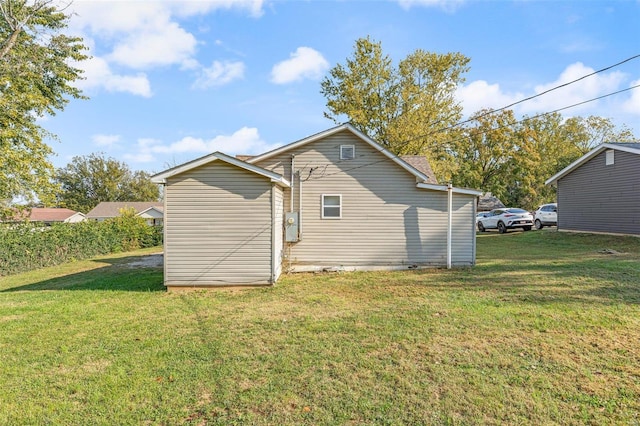 rear view of property with a yard