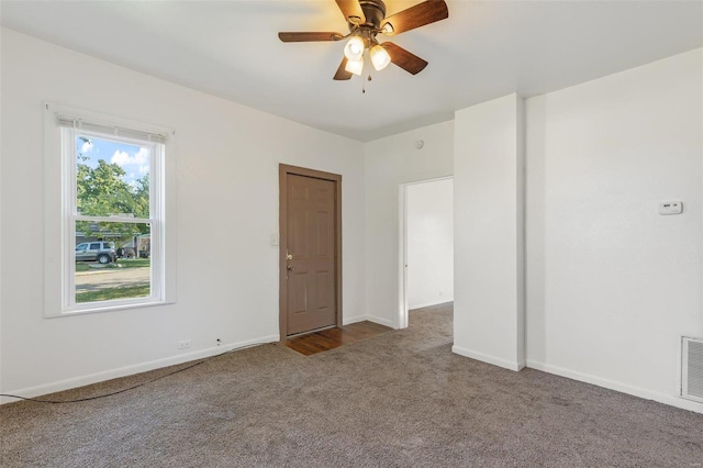 spare room featuring ceiling fan and carpet flooring