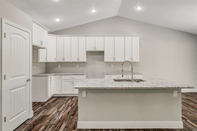 kitchen featuring a center island with sink, white cabinets, vaulted ceiling, and sink