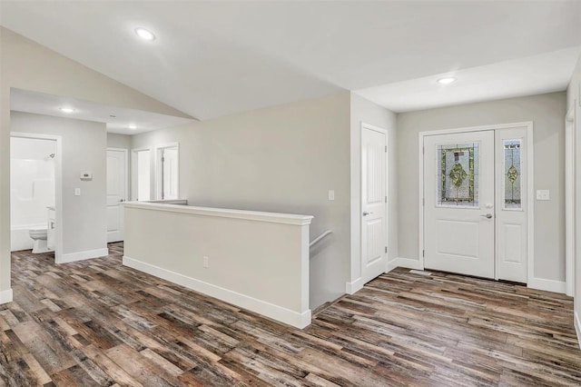 entryway with dark hardwood / wood-style floors and vaulted ceiling