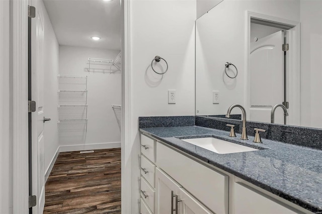 bathroom with hardwood / wood-style floors and vanity