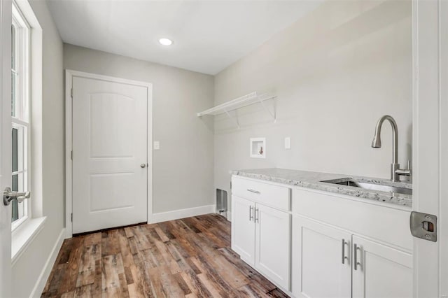 laundry area with washer hookup, cabinets, dark hardwood / wood-style flooring, and sink