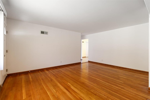 empty room with hardwood / wood-style flooring