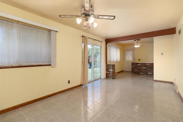 spare room featuring beam ceiling, ceiling fan, and light tile patterned floors