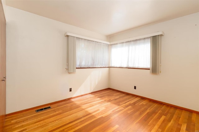 empty room with wood-type flooring