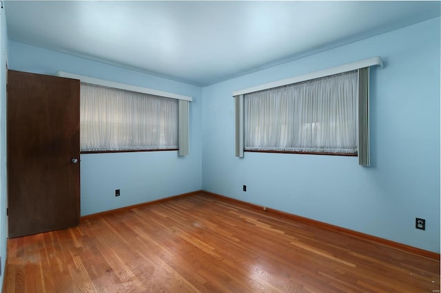 empty room with light hardwood / wood-style floors