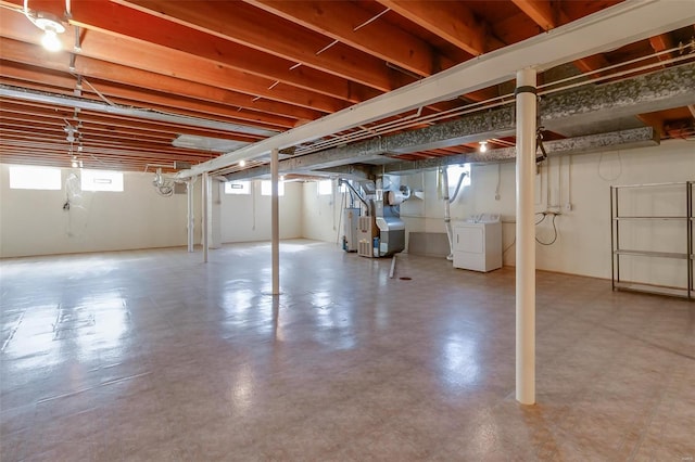 basement with gas water heater and washing machine and clothes dryer