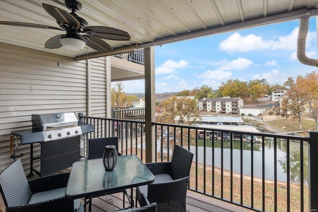 exterior space featuring grilling area, a water view, and ceiling fan