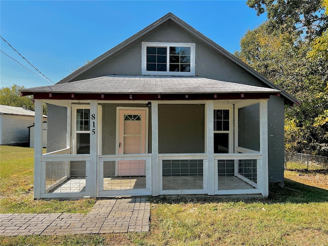 back of house with a lawn